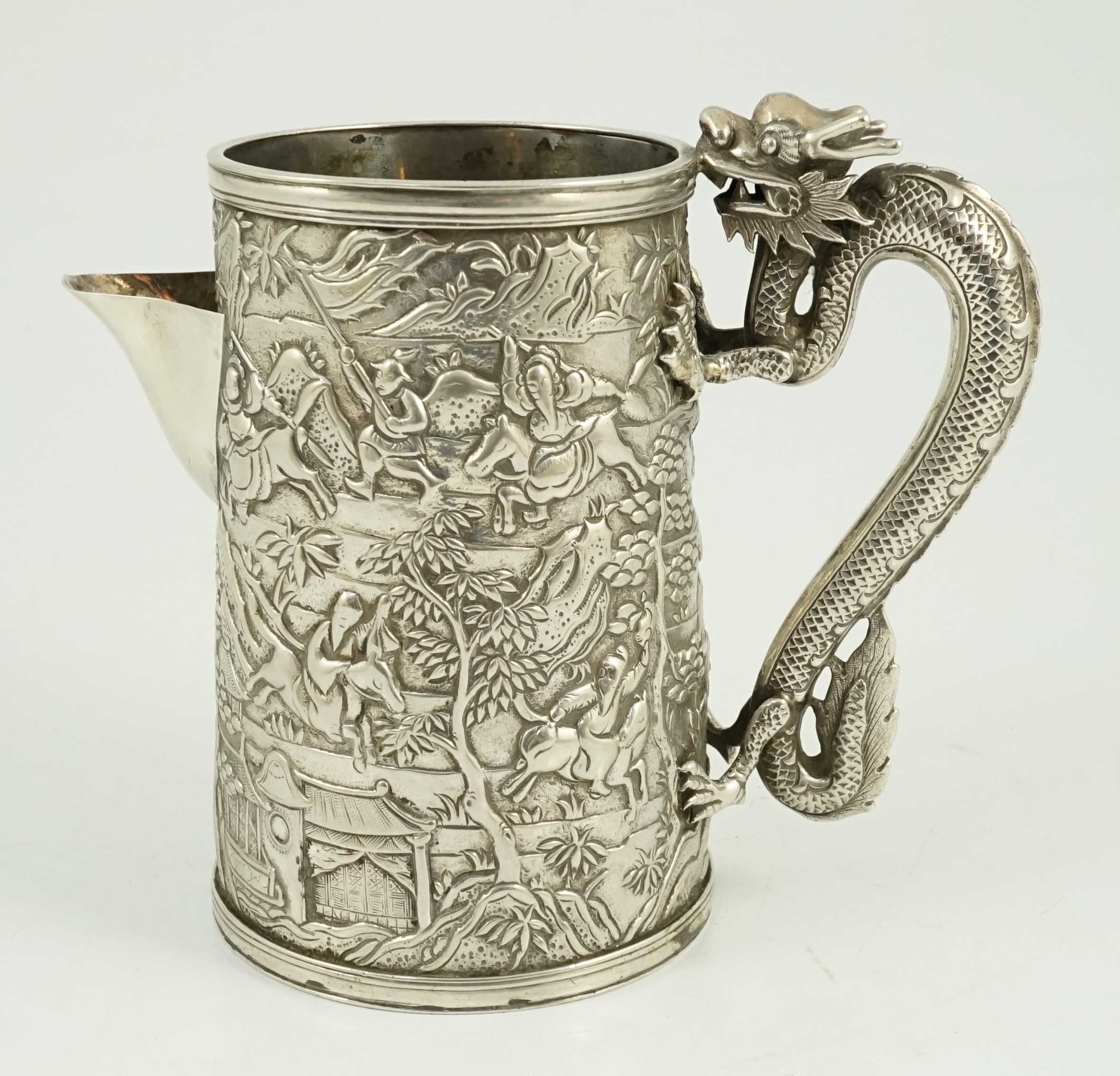 A Chinese embossed white metal mug, now converted to a jug, maker possibly LC or LO